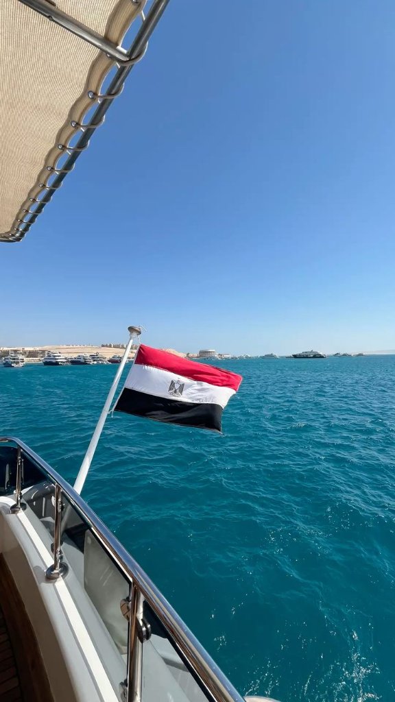 Egyptian flag on a boat with Hurghada marina in the background