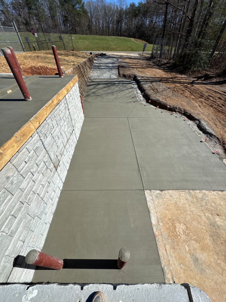 Commercial concrete sidewalk and curb with retaining wall