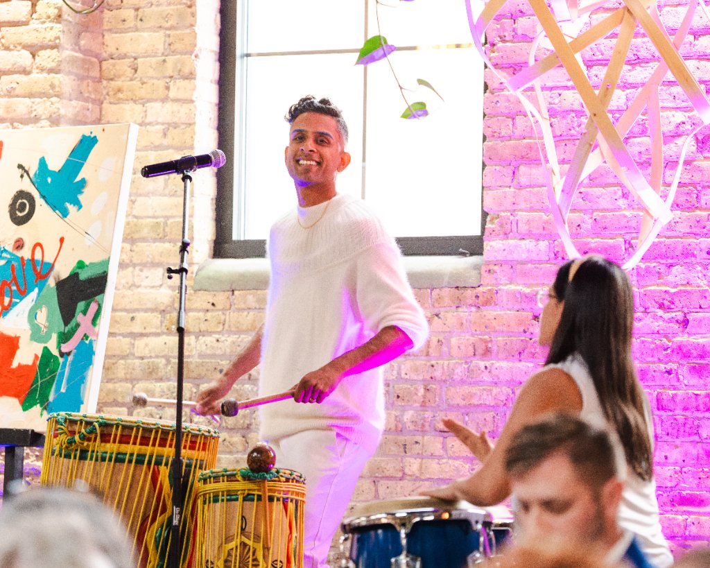 Performer playing drums during an Art vs. Food benefit celebration