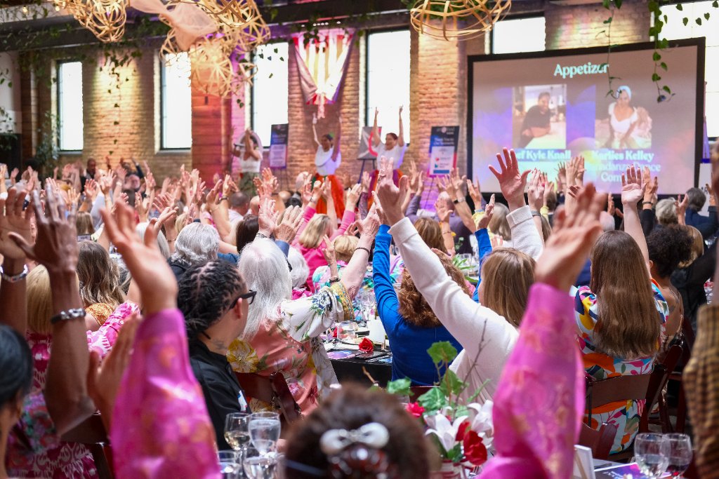 Art vs. Food — a full room of guests raising their hands during the program