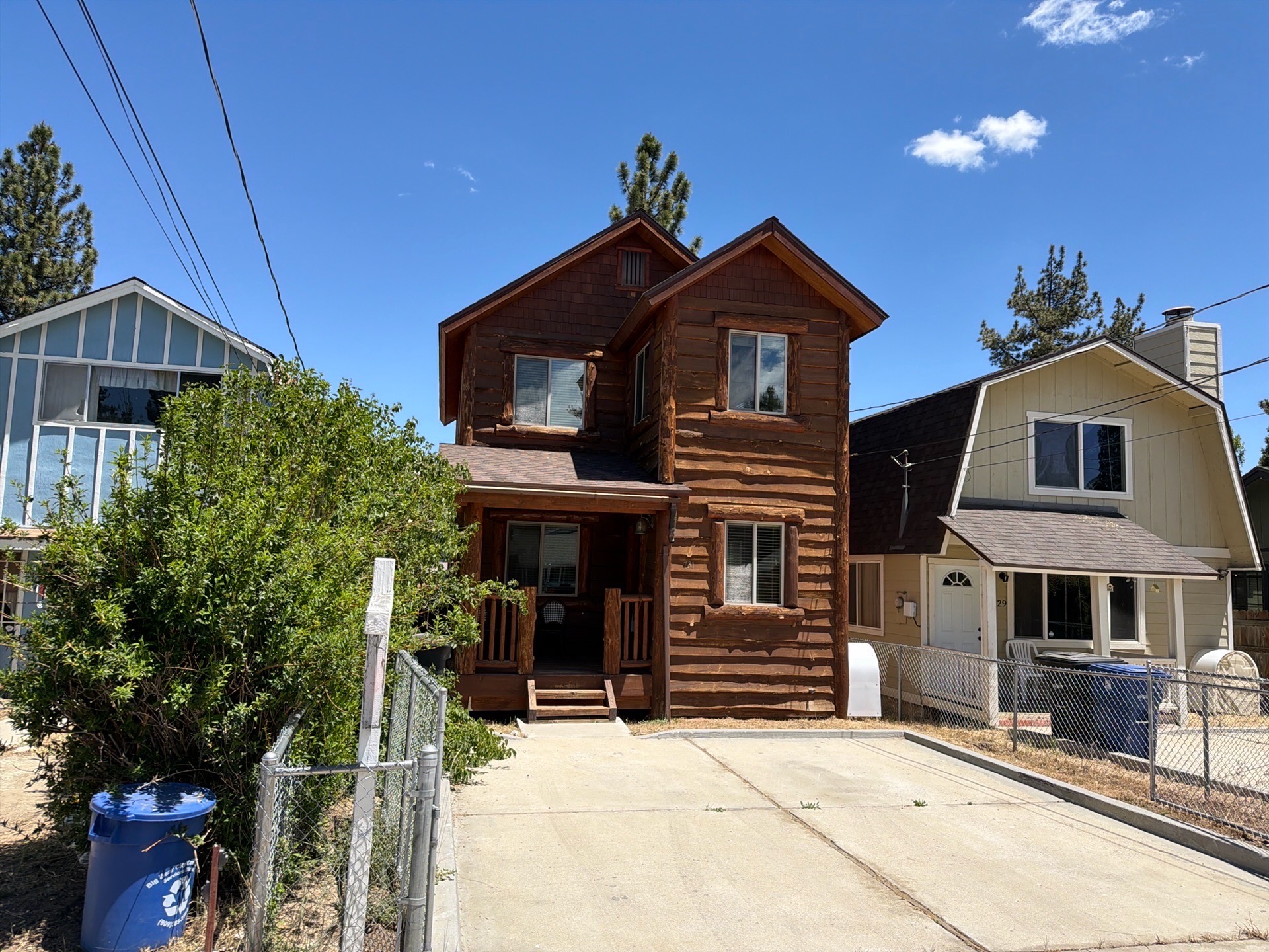 Two-story log-style home with covered front porch