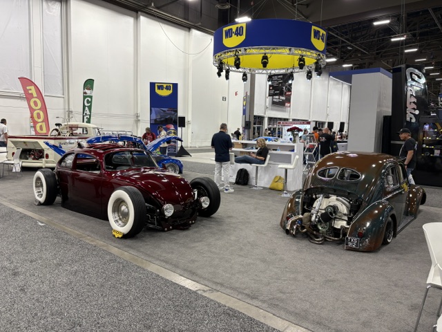 Custom VW Bugs — maroon rat rod and copper coupe, WD-40 booth