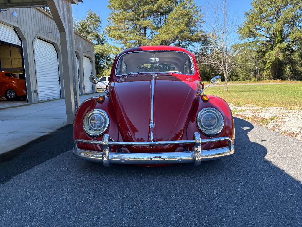 Front view — deep red paint, chrome bumper, halo headlights, custom mirrors