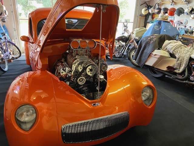Engine bay open — supercharged V8, polished to perfection