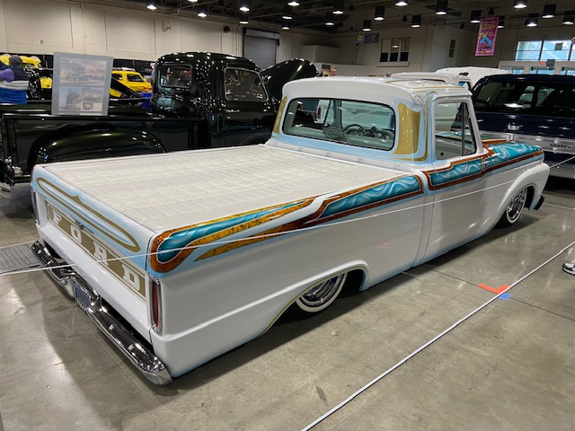 White Ford truck — teal and gold pinstripe, GNRS show floor