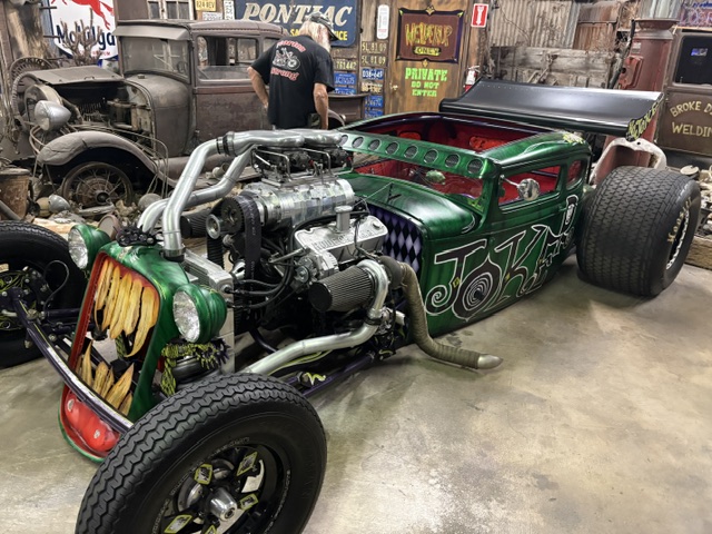 "Joker" green rod — twin-turbo, custom graphics, indoor shop