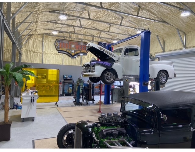 Shop floor view — 1931 Chevy and 1950 Ford side by side