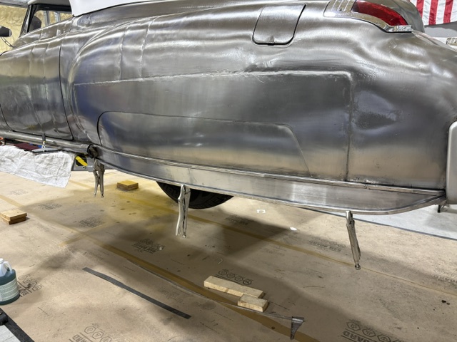 Rocker panel detail — hand-formed 18-gauge steel trim clamped for fitting