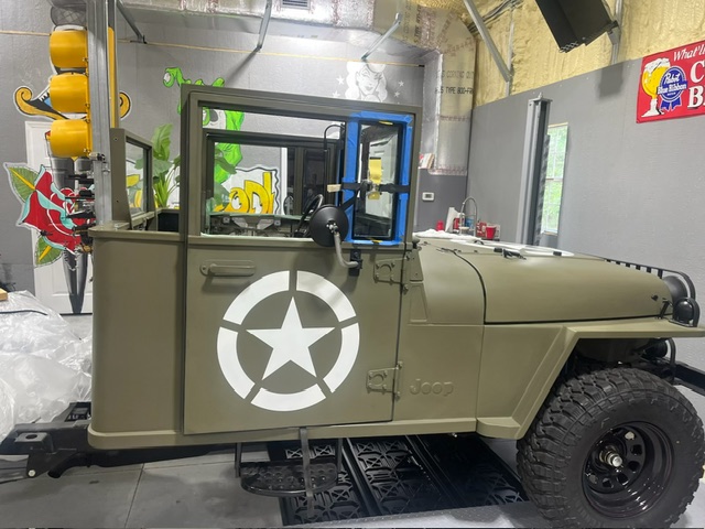 In the glass shop — custom windshield and power window frames being fitted