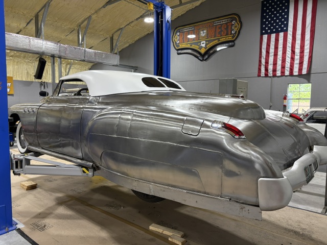 Rear three-quarter — full roadster profile emerging in bare metal