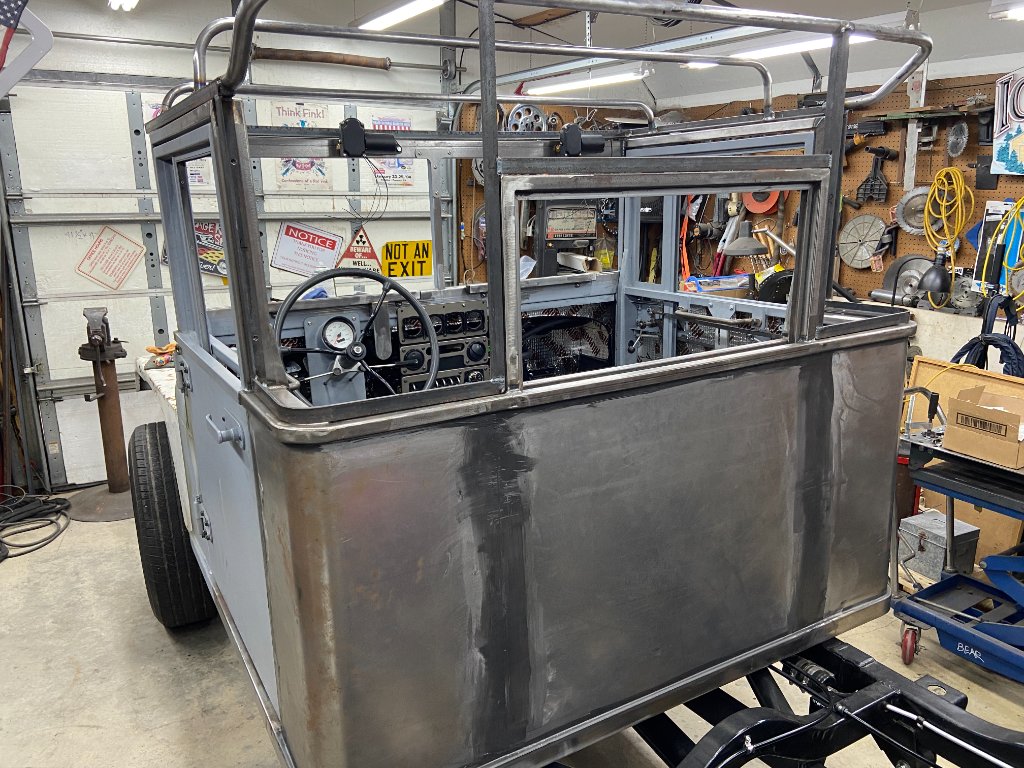 Before — bare metal body tub, custom tube frame cage, hand-built from scratch