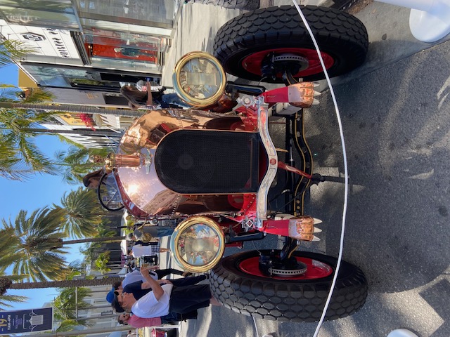 Front three-quarter — copper nose, huge headlamps, red wheels