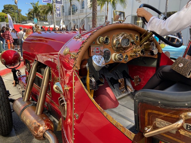 Red racer #8 profile — riveted copper bodywork, massive tires