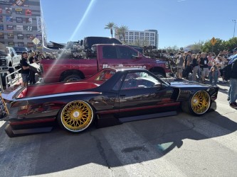 Black Ranchero on gold billet wheels — slammed, outdoors at SEMA