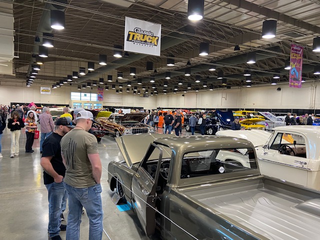 Classic Truck show floor — C10s and hot rods under banner