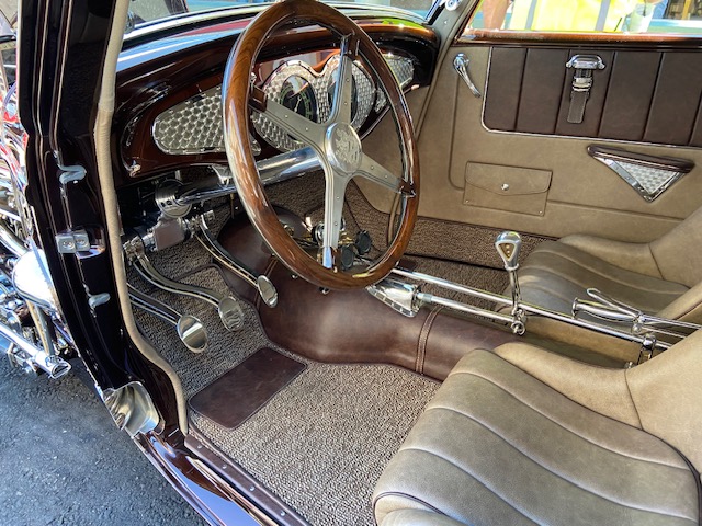 Cadillac V16 engine bay — chromed headers, leather straps
