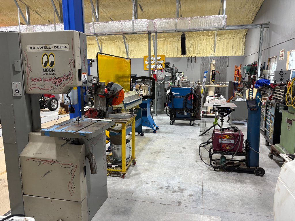 Fabrication bay — Rockwell/Delta bandsaw, Miller welder, press brake, plasma cutter