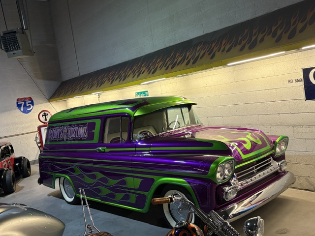 Count's Kustoms panel van — purple and green flames, I-75 sign