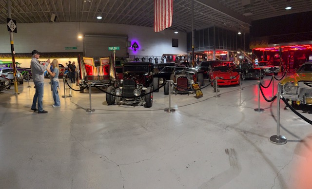 Indoor show — T-bucket roadsters and customs under American flag