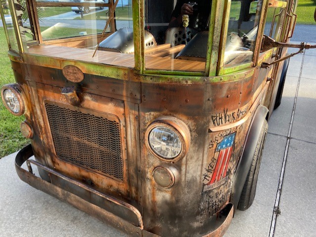 Front detail — patina finish, original headlights, hand-lettered bodywork