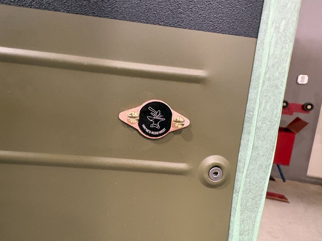 Wayne's Rods West signature plaque — copper badge with logo, brass screws