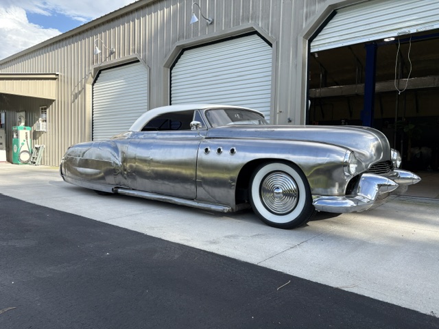 Full side view — the finished roadster conversion outside the shop