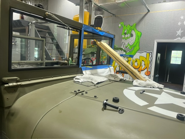 Windshield area — custom frame and glass being set and masked