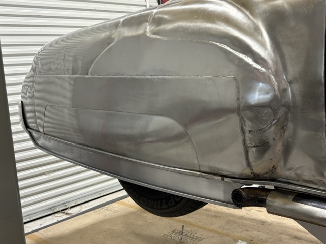 Front lower quarter — forward extension blending with the front fender