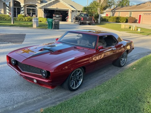 Driver's side profile — show-quality stance, candy red over modern wheels