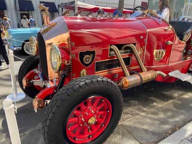 Cockpit of the red racer — brass gauges, leather wrap, wooden dash