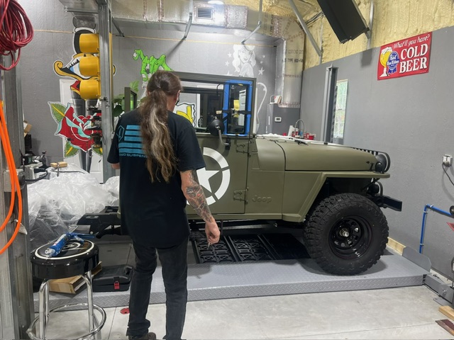 Wayne's Rods West tech inspecting the custom glass fitment