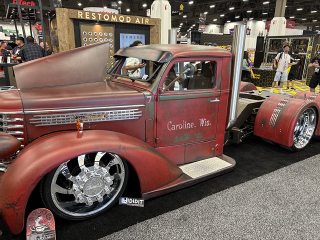 "Caroline, Wis." patina cab-over truck — chrome dualies, SEMA floor