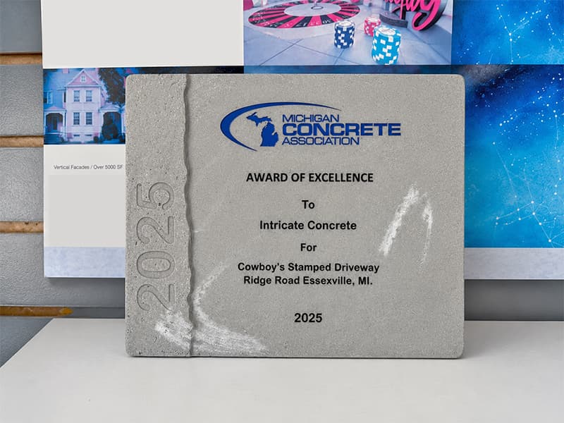 Michigan Concrete Association Award of Excellence concrete plaque presented to Intricate Concrete for Cowboy's stamped driveway on Ridge Road in Essexville, MI in 2025