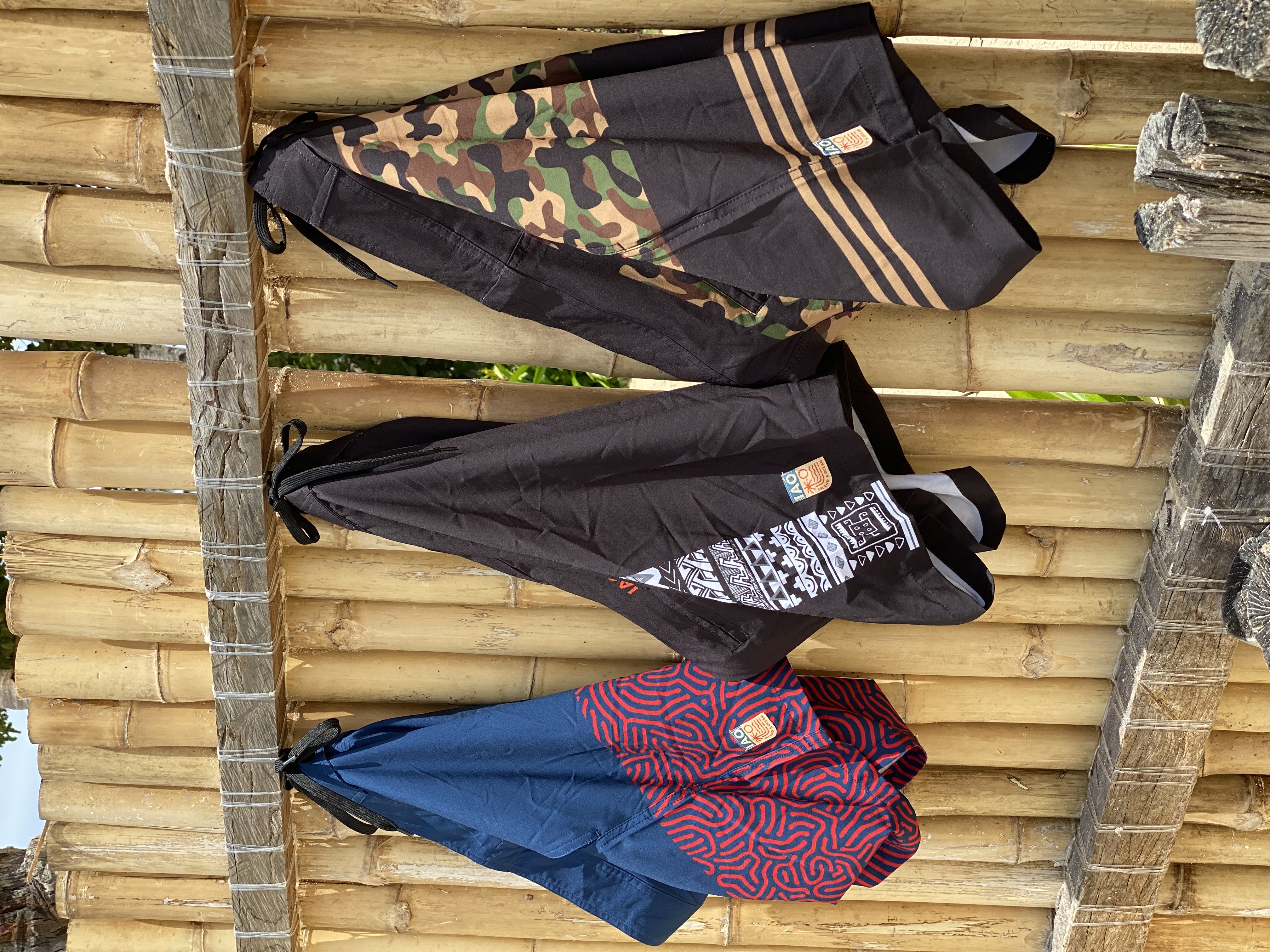 IAO boardshorts hanging on a bamboo wall in Siargao