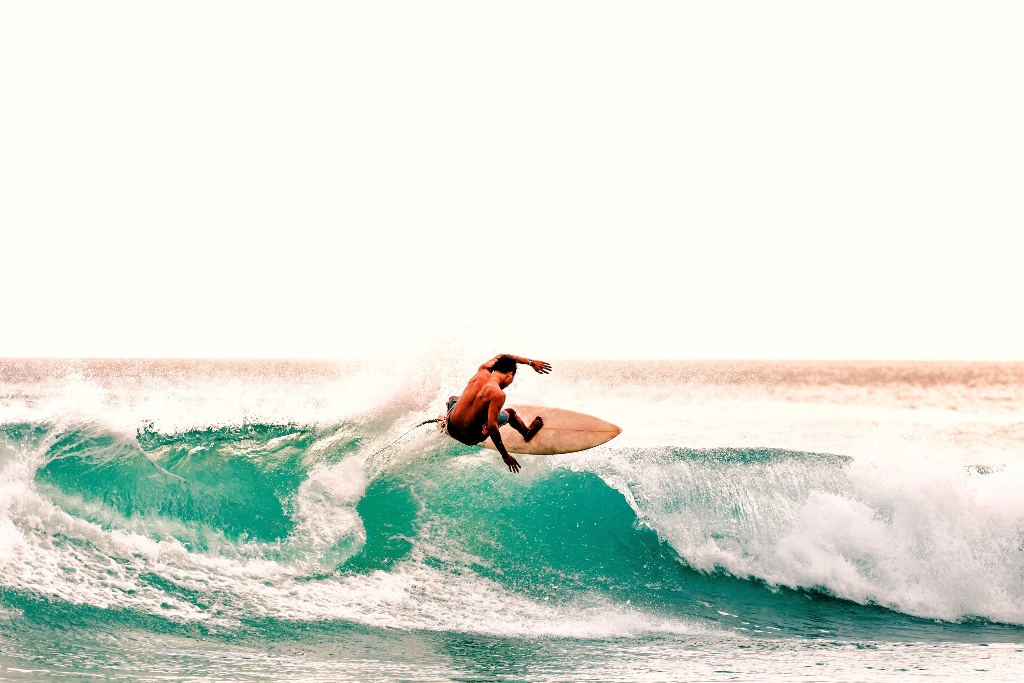 Surfer riding a turquoise wave