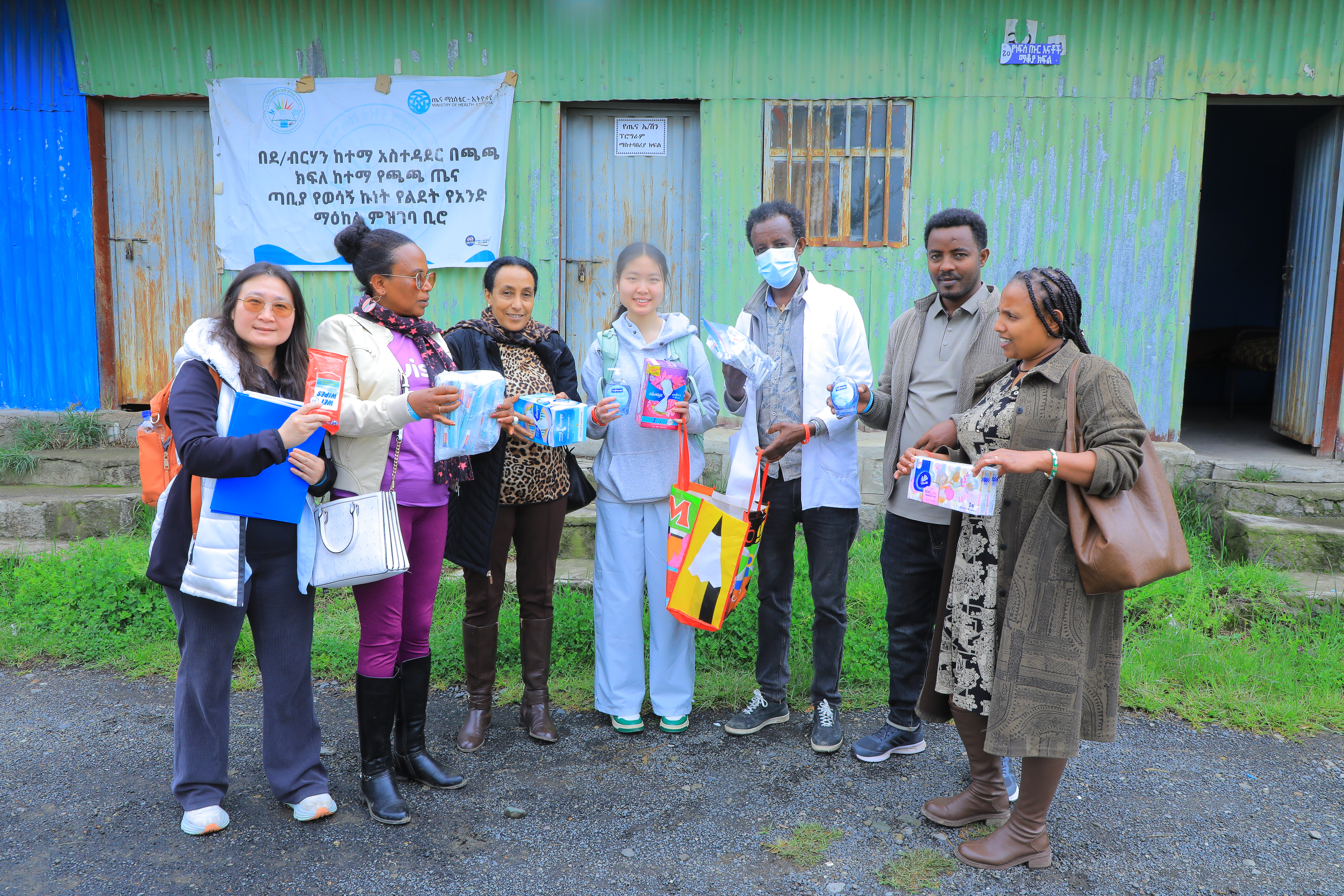 Distributing sanitary pads and hygiene supplies at a community health site.