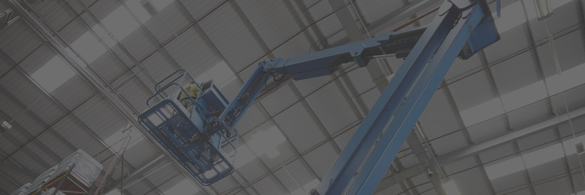 Boom lift installing LED high bays in a warehouse