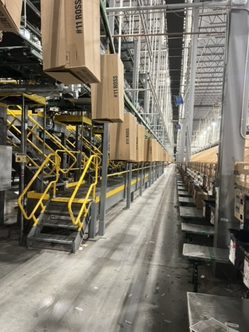 Warehouse facility before and after an ecoZohm LED upgrade — Stair access & put wall aisle — after