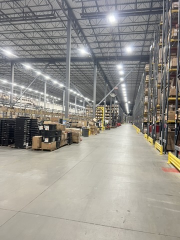 Warehouse facility before and after an ecoZohm LED upgrade — Rack row main aisle — after