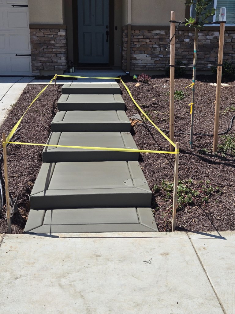 New concrete entry steps and walkway with caution tape