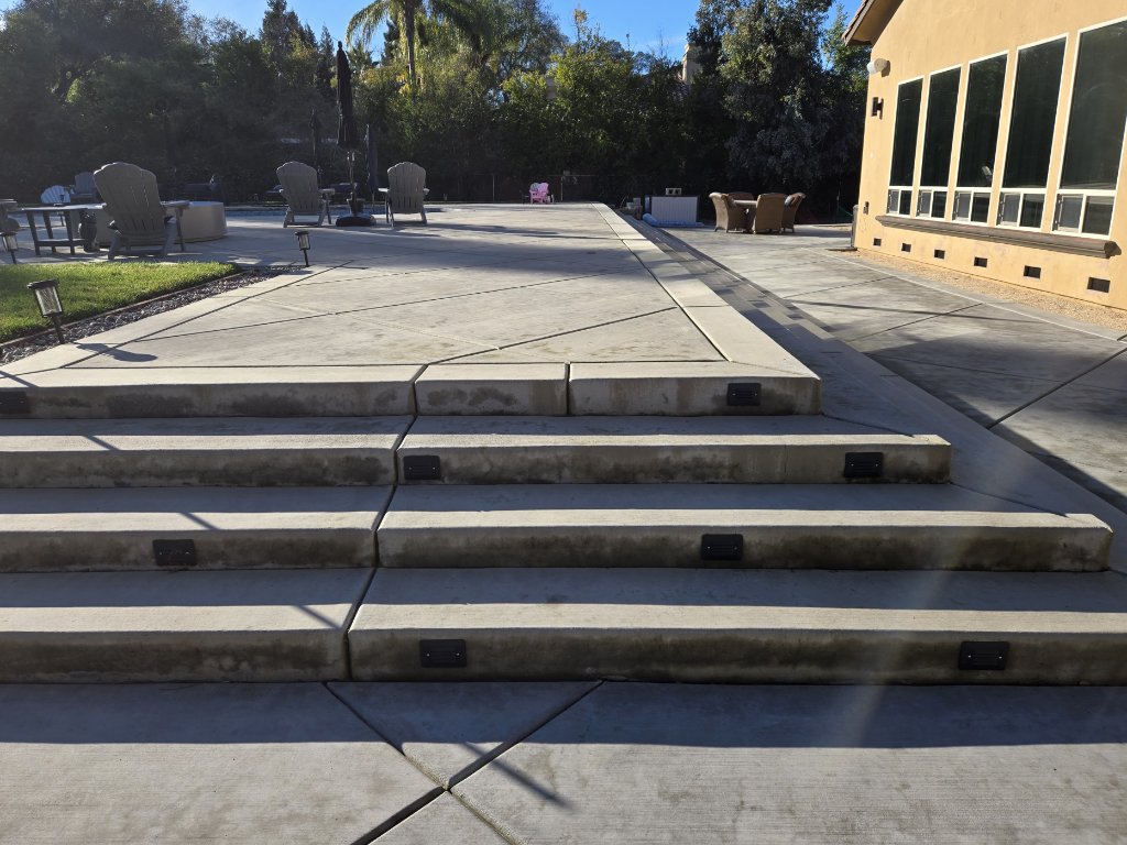 Crew finishing large concrete slab pour
