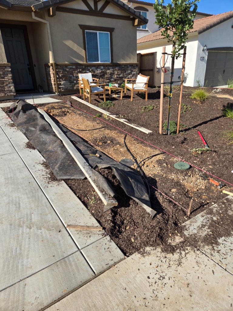 Large concrete patio with steps and outdoor furniture