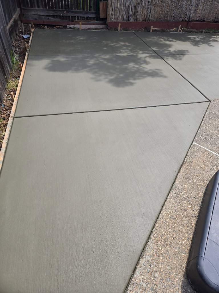 Finished pool deck with blue pool visible