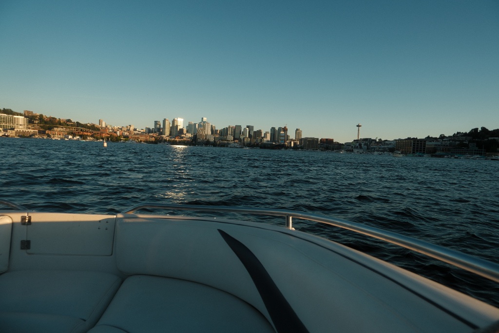 Premium wake boat on Lake Washington at sunset