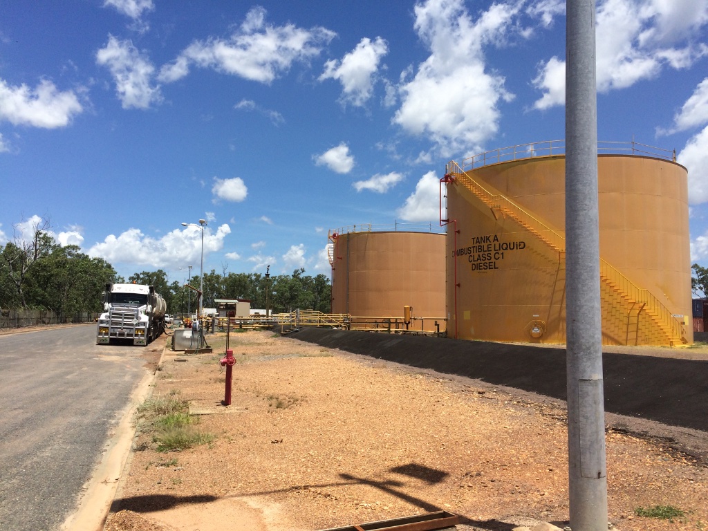 Bulk petrol storage tanks at fuel depot with tanker truck