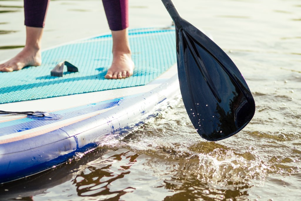 Stand-up paddleboarding at sunrise