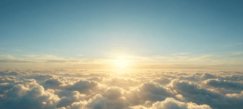 High above a sea of sunset clouds, the sun low on the horizon.