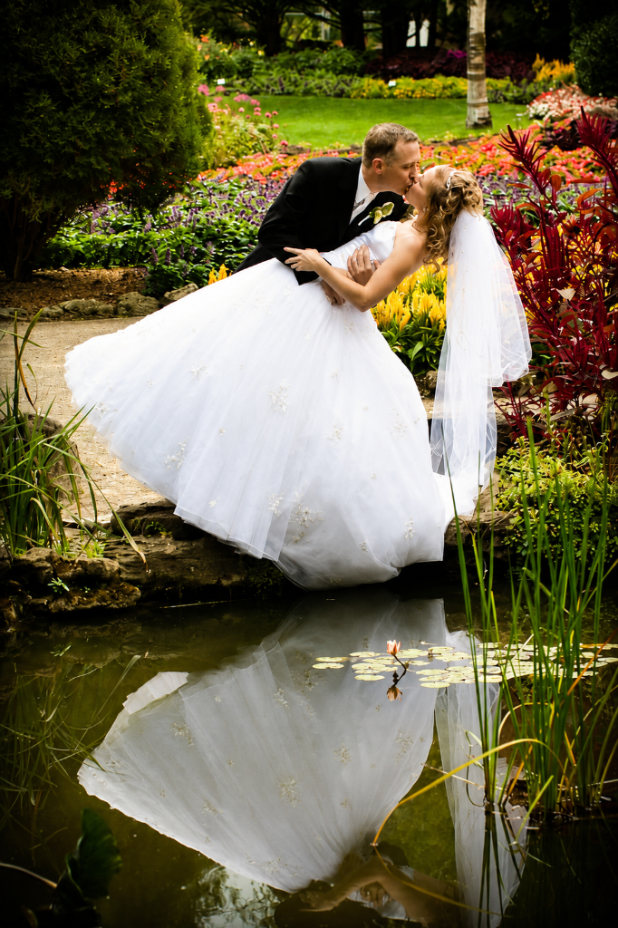 Bride and groom kissing next to Pond in Hamilton Ontario