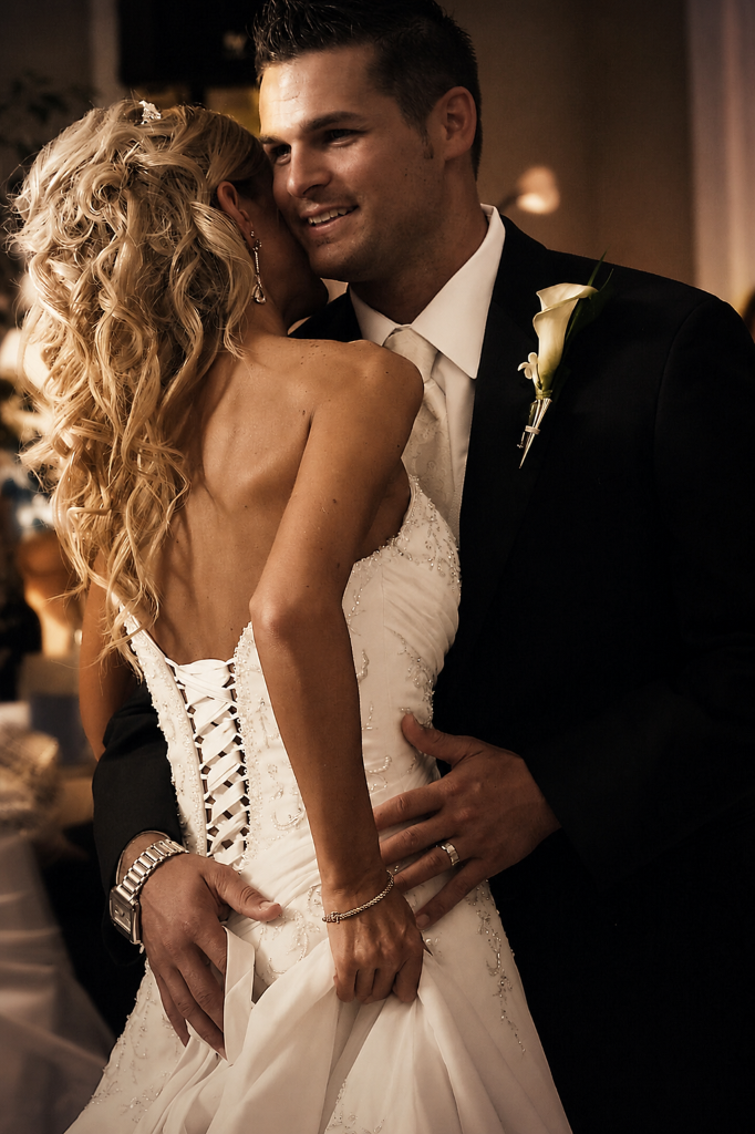 Groom holding bride from behind