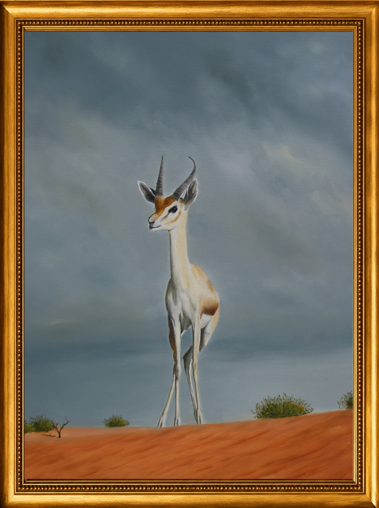 A reem gazelle stands sovereign on a red dune crest against a stormy sky — its graceful form a symbol of untamed desert freedom.